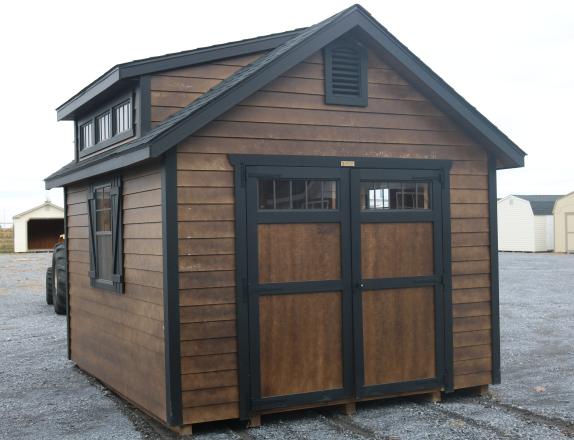 Pine Creek 10x12 Cape Cod with Coffee Polyurethane walls, Black trim and Black Z-Style shutters, and Charcoal shingles